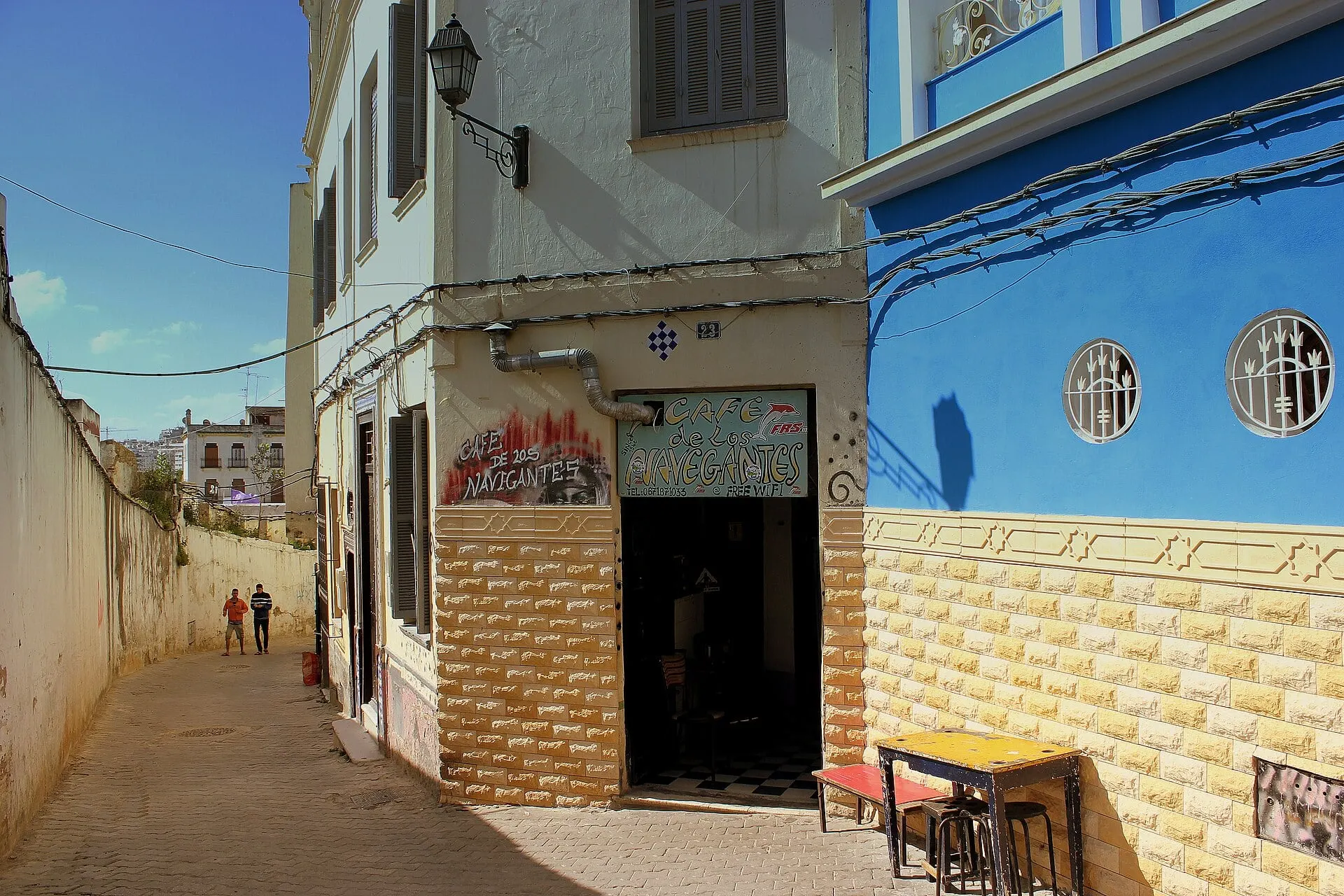 A narrow lane and the blue walls of Café Navigantes in the medina of Tangier