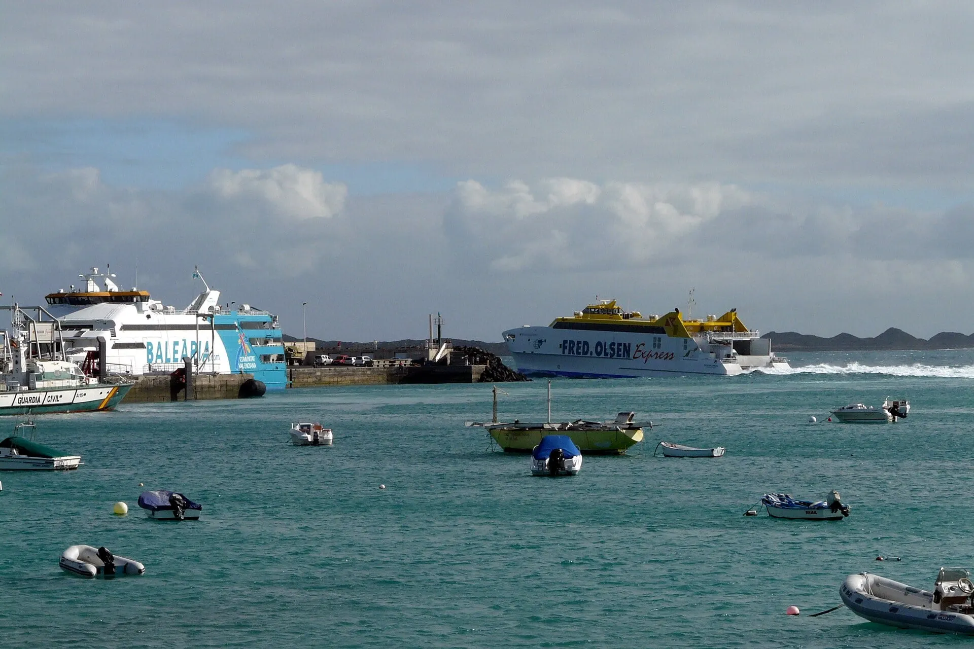 Ferries in Corralejo harbour with small boats moored in the bay