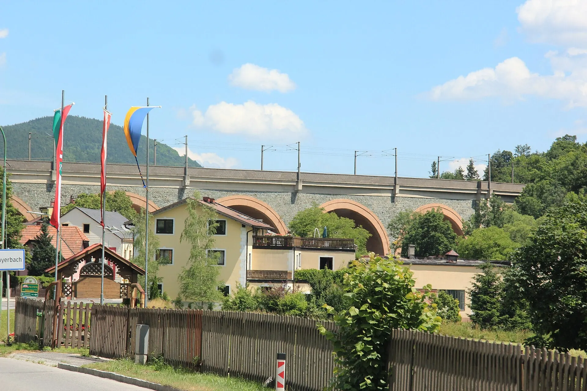 The arches of the Schwarza viaduct of the Semmering Railway above houses in Payerbach
