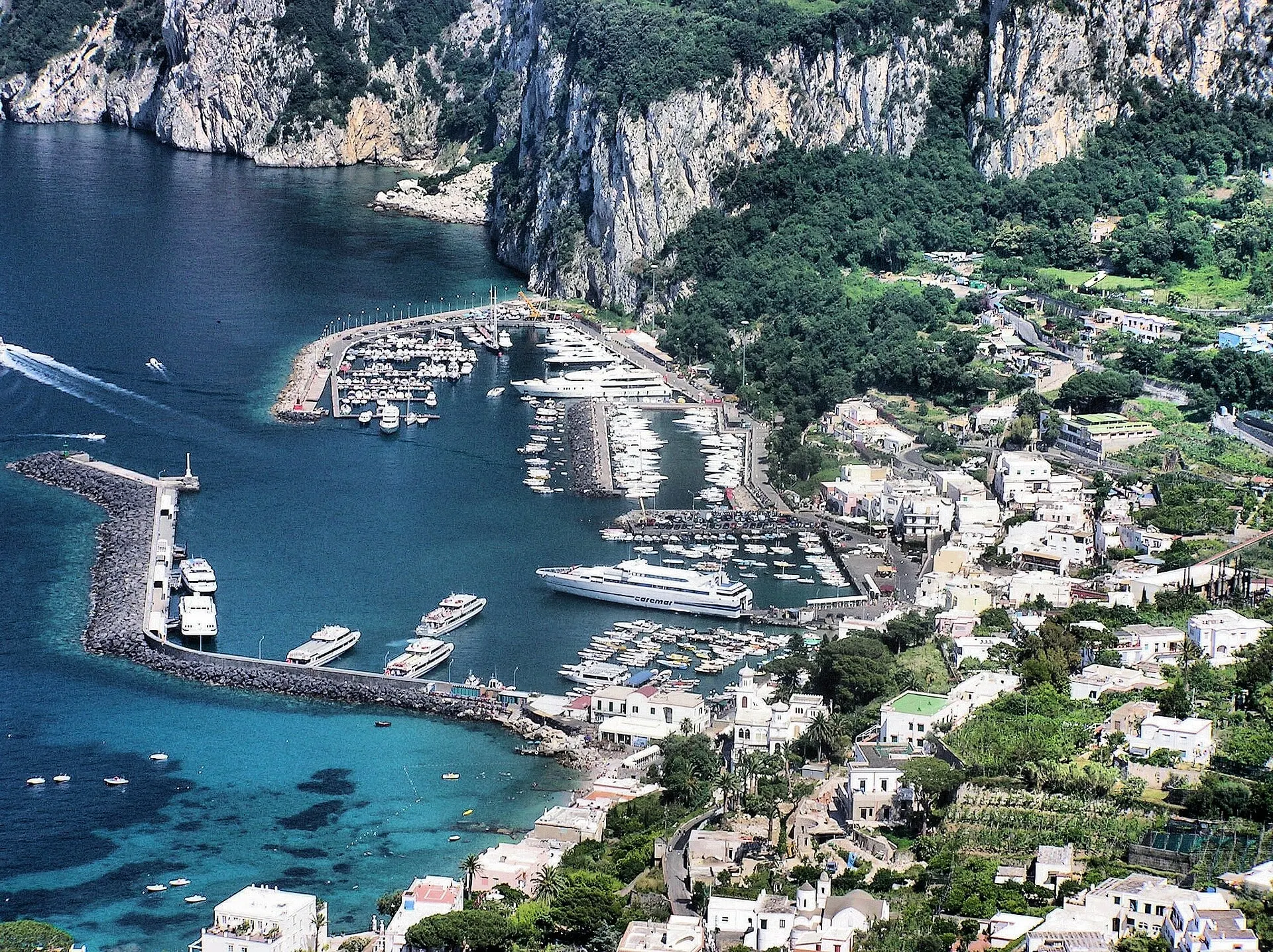 The harbour of Marina Grande on Capri seen from above, with boats moored inside the breakwater