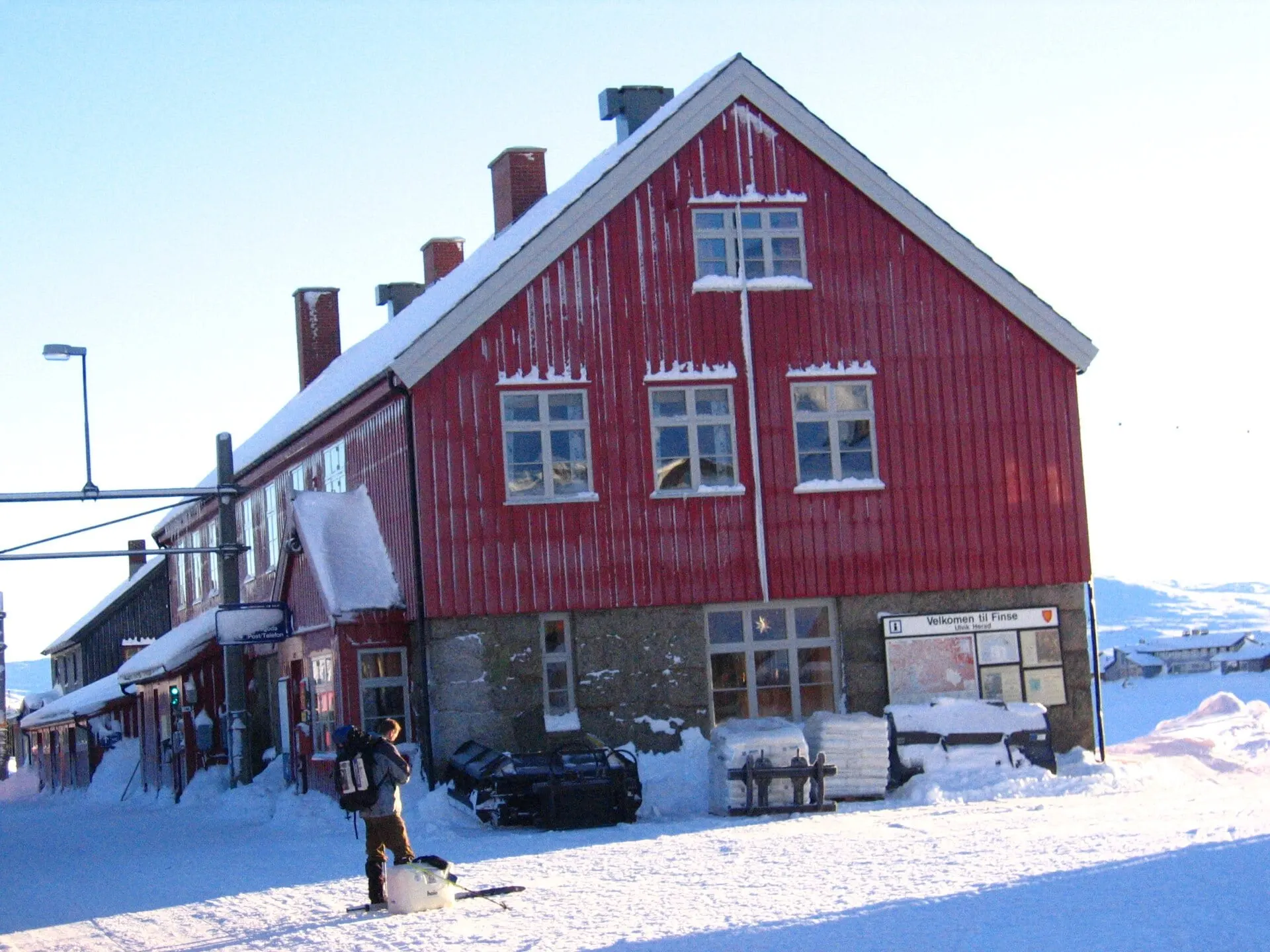The red wooden station building at Finse in deep winter snow.