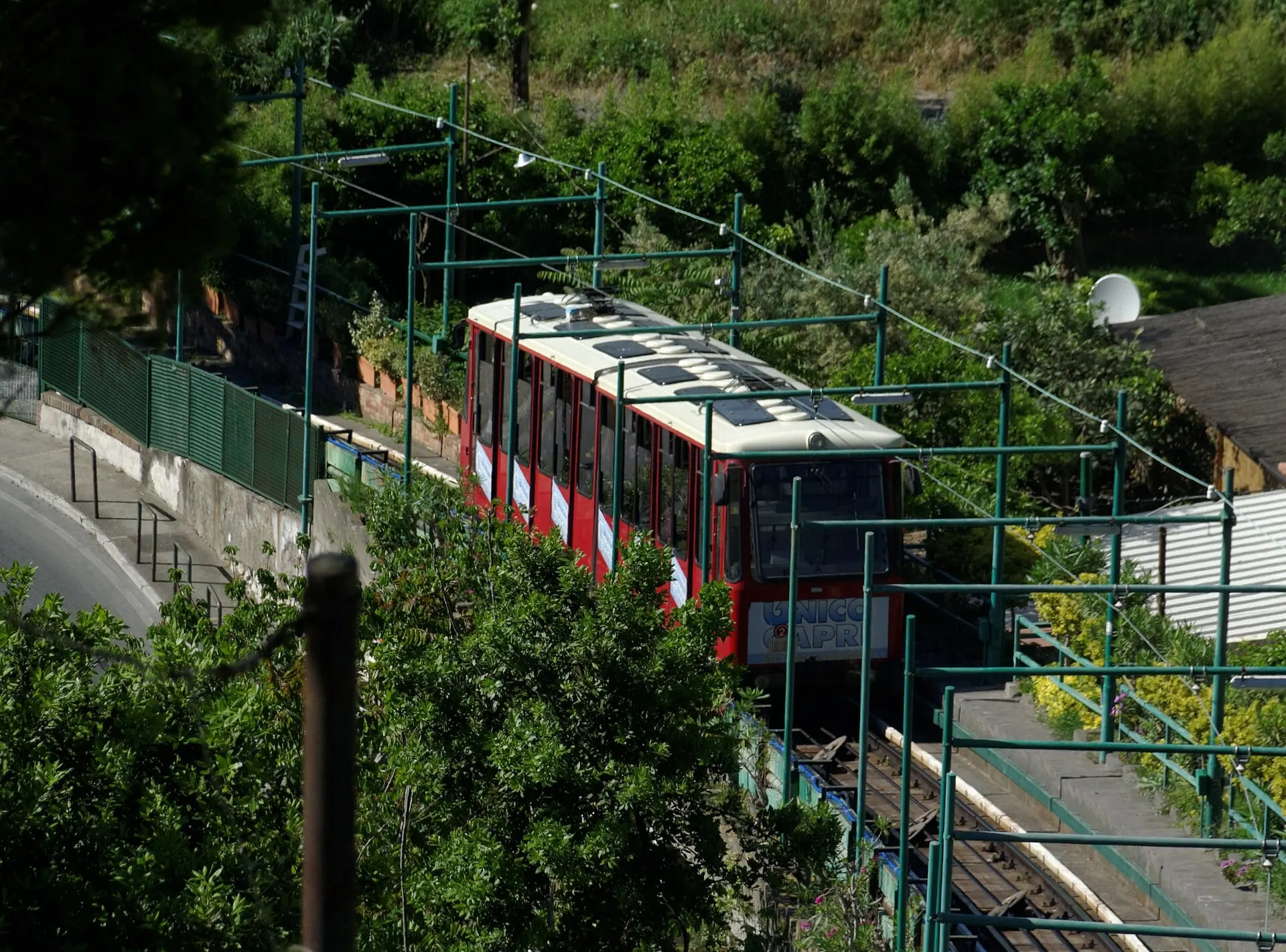 The red funicular climbing between gardens from Marina Grande up to Capri town