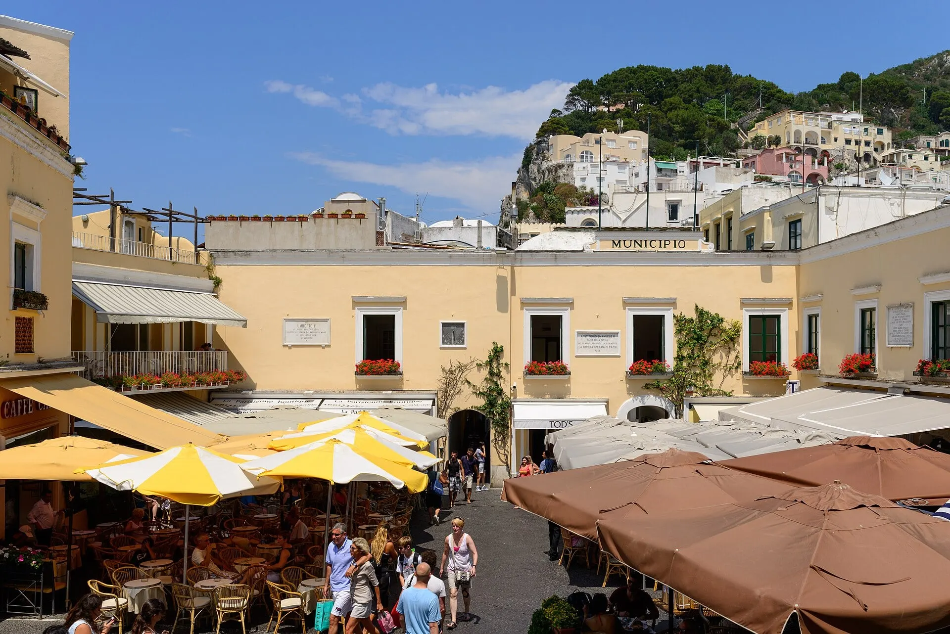 Cafe tables under umbrellas in the Piazzetta, the main square of Capri town