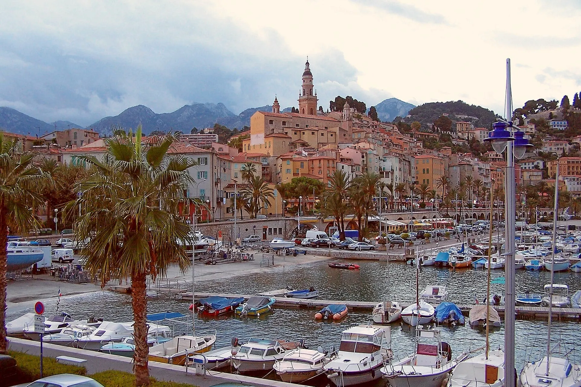 Menton's old town and church tower rising above the boats in the harbour.