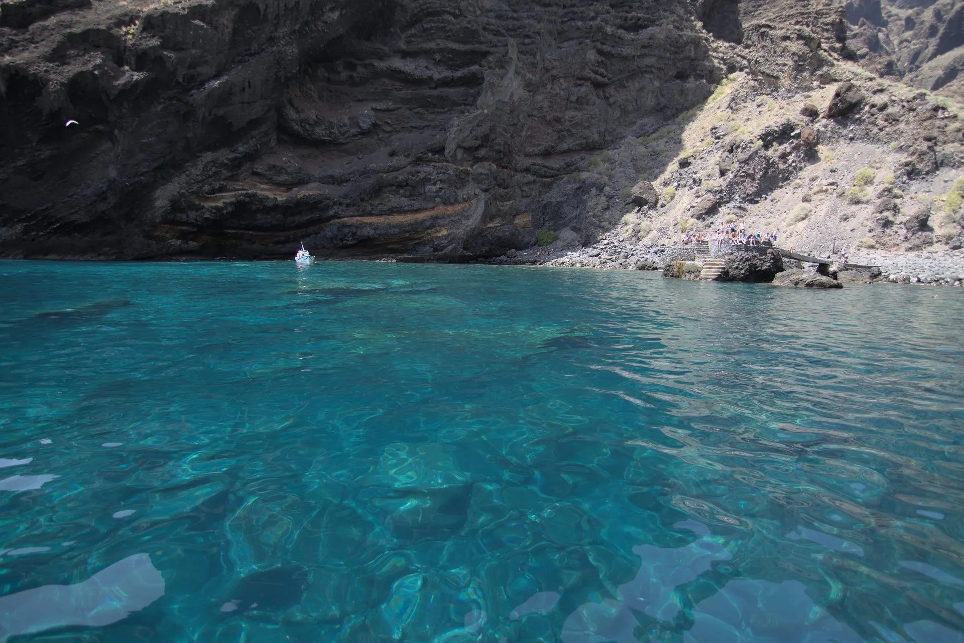 Clear turquoise water at the foot of the cliffs