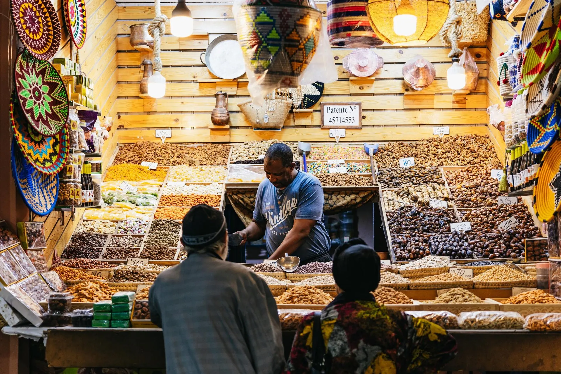 A dried fruit and nut stall in the souk at night, with dates, figs and almonds in trays