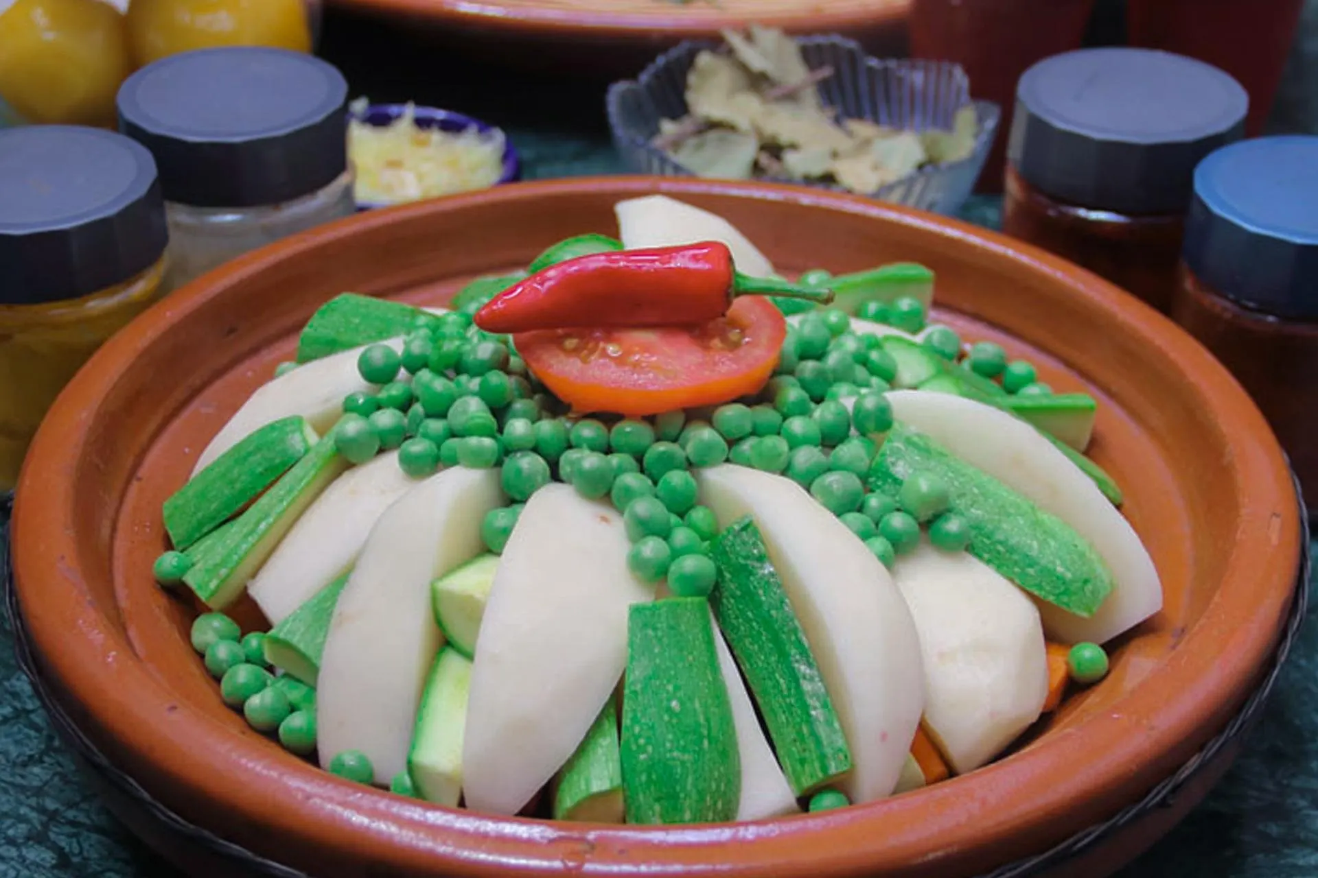 A vegetable tagine built up in its clay dish, ready for the fire