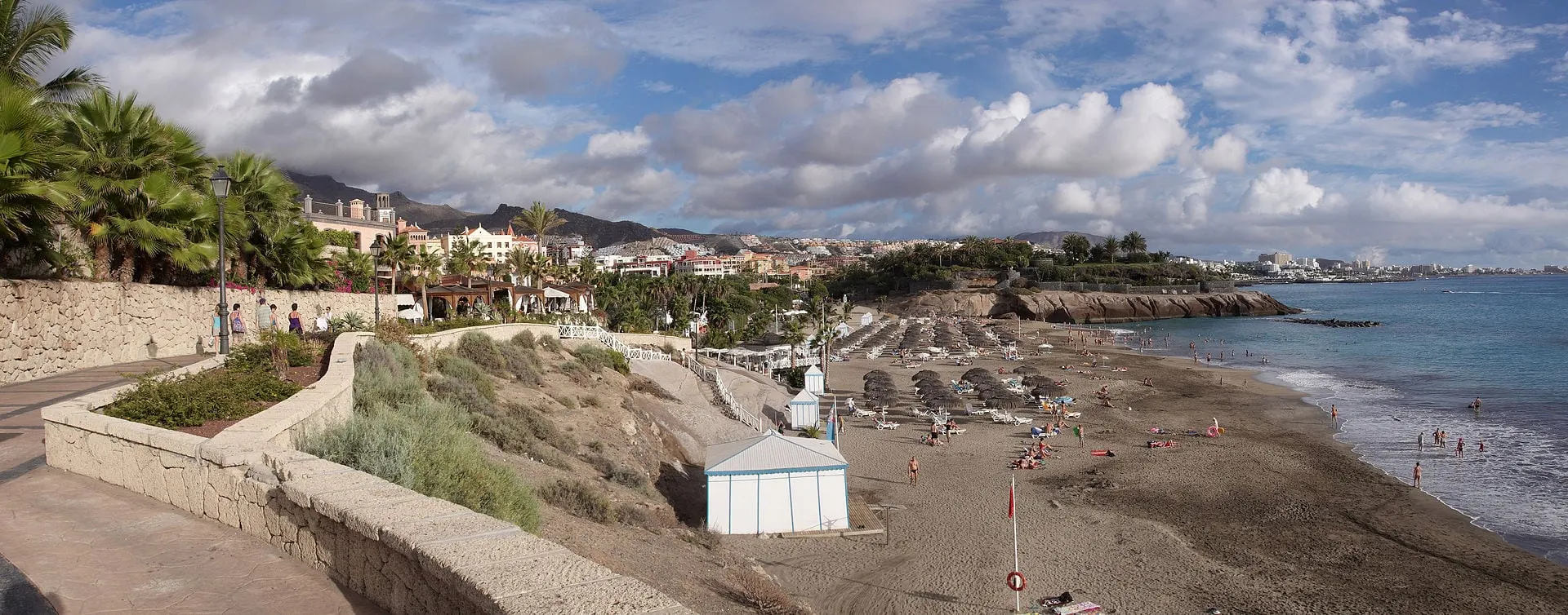 Playa del Duque in Costa Adeje, south Tenerife, with sunbeds below the resort hotels