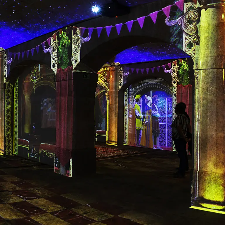 Projected banners, columns and figures on the vaulted walls of the gallery during the Porto Legends show