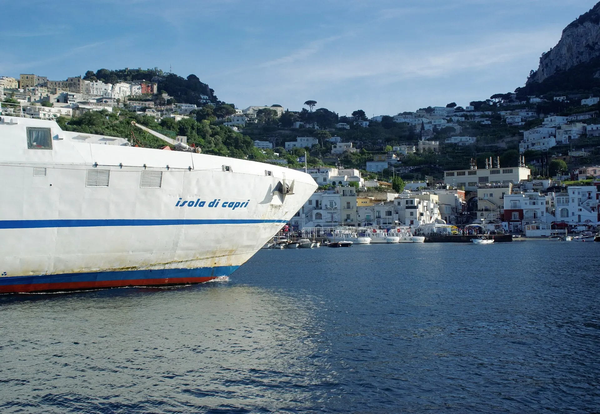 A ferry entering the harbour of Marina Grande below the white houses of Capri