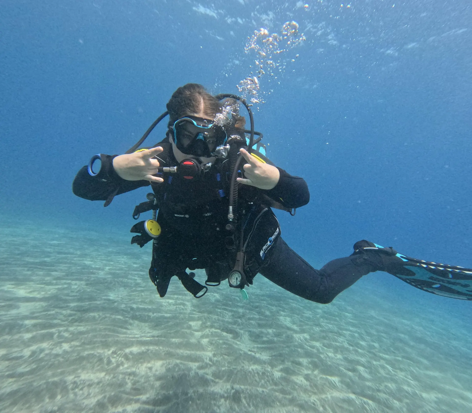 A diver hovering above the sandy seabed