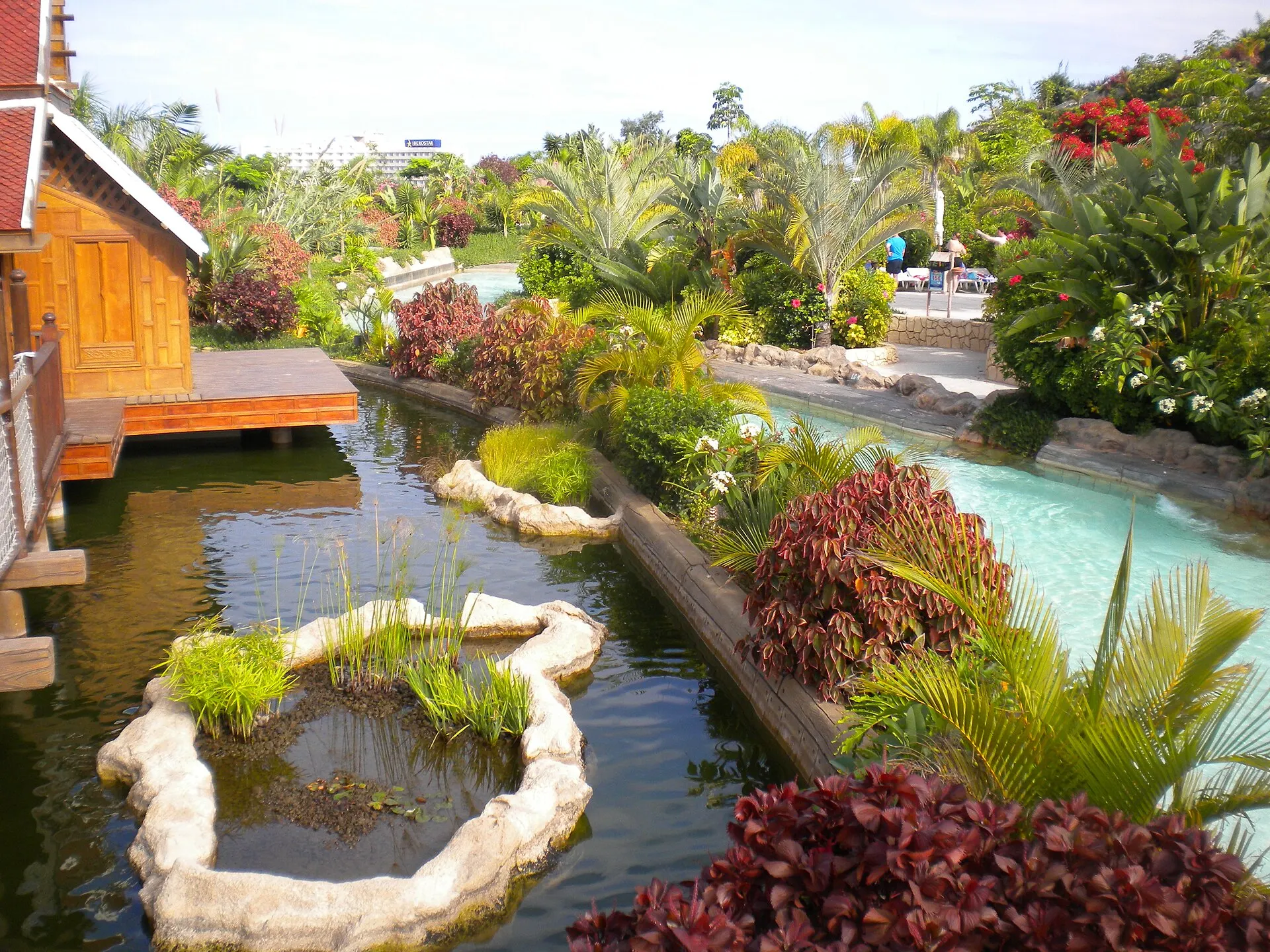 The Mai Thai River winding past a Thai-style pavilion at Siam Park