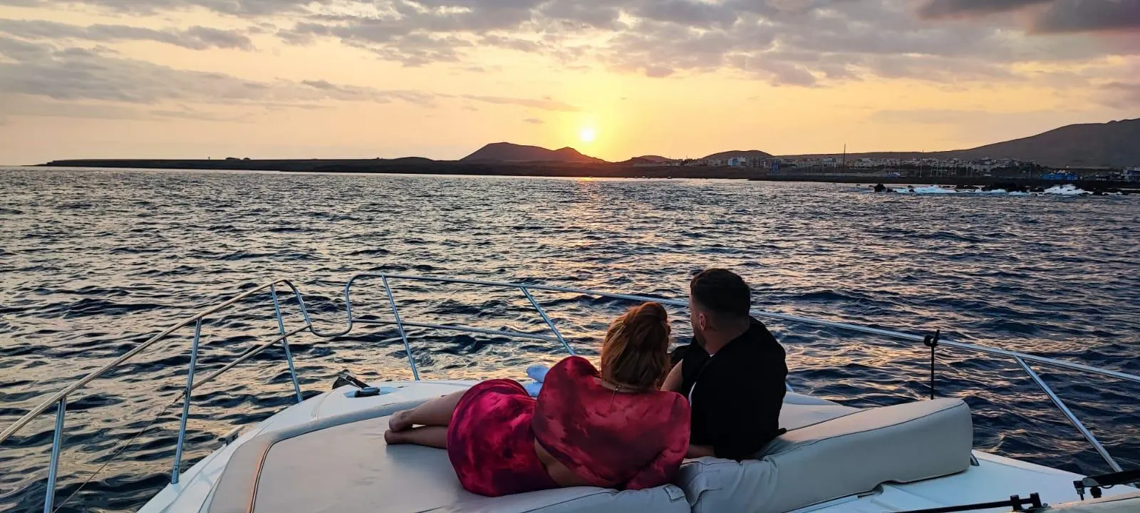 A couple on the foredeck at sunset
