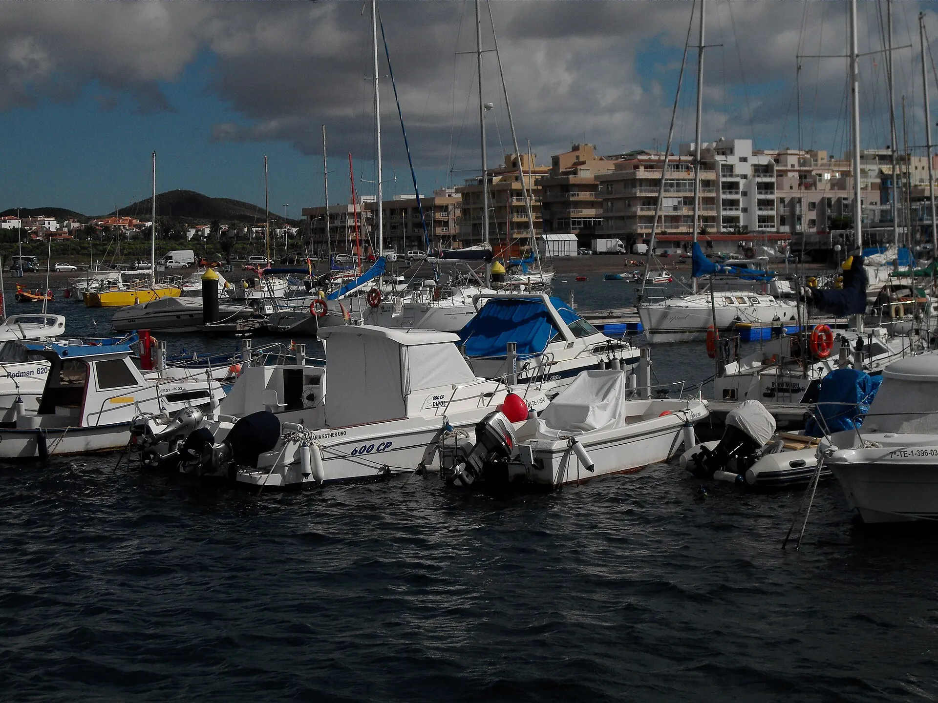 Boats moored at Marina del Sur in Las Galletas, with the town behind