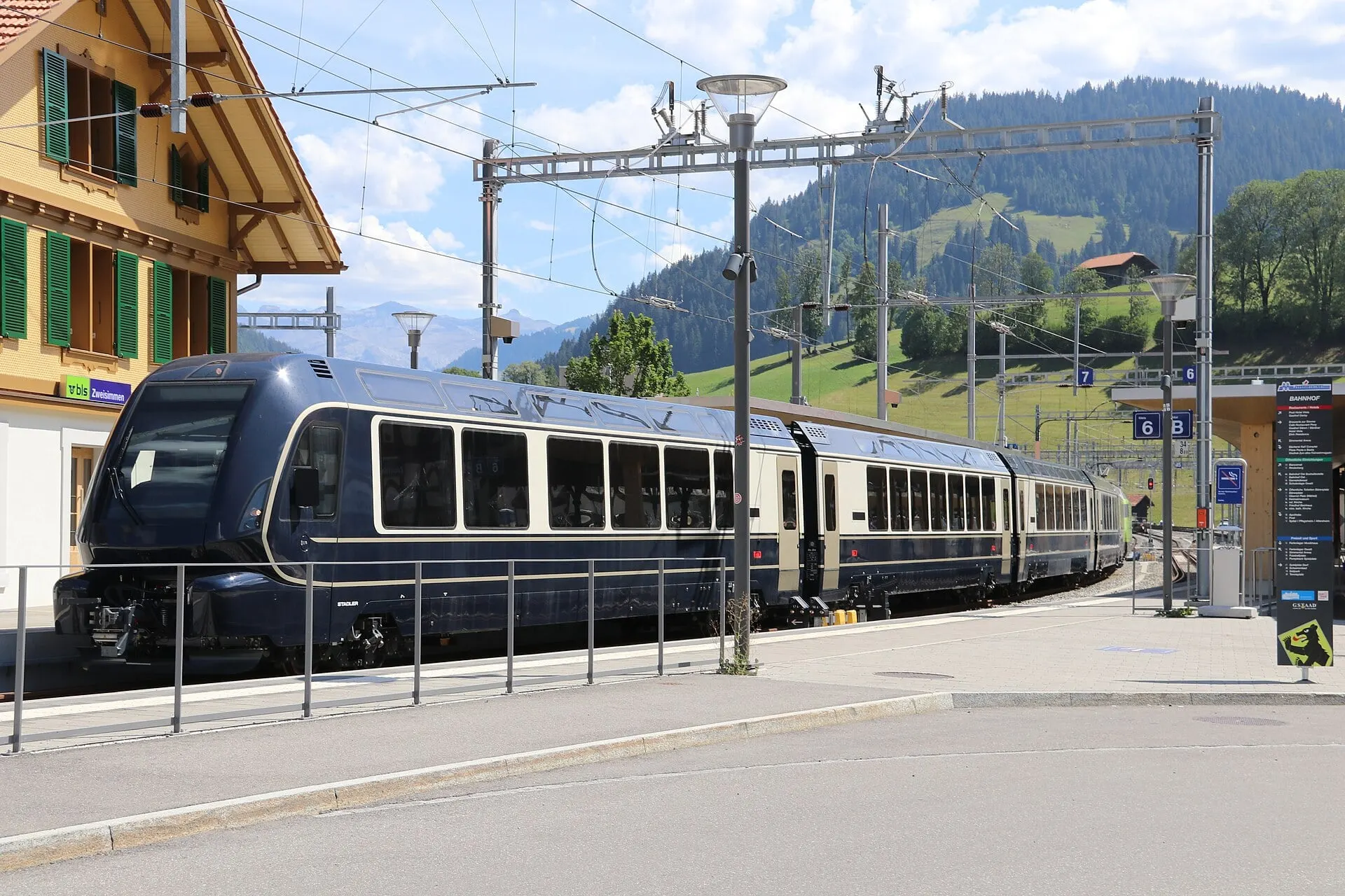 The dark blue GoldenPass Express waits at Zweisimmen station, where it changes gauge.