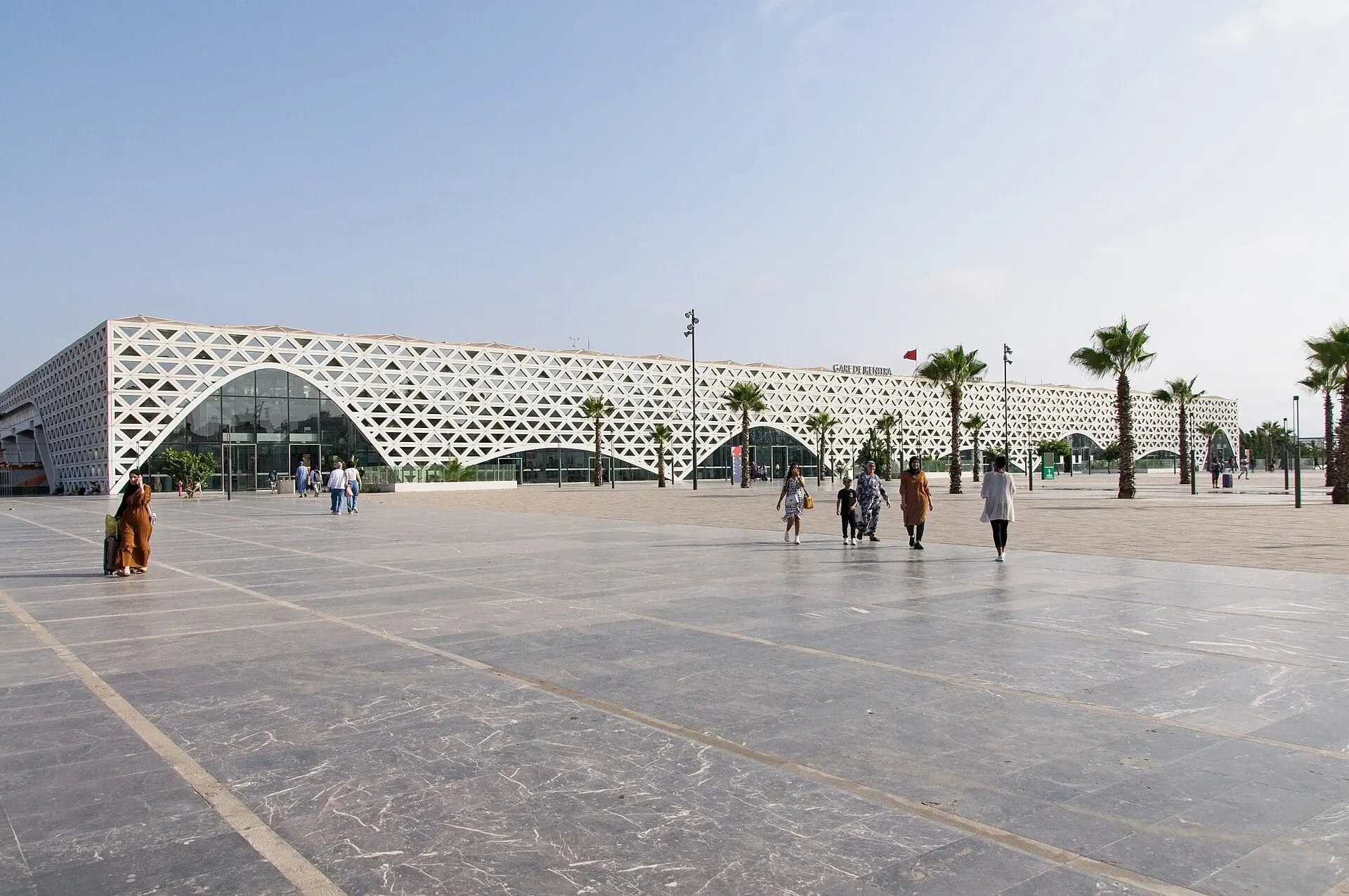 The white lattice façade and palm lined forecourt of Kénitra station on the Al Boraq line