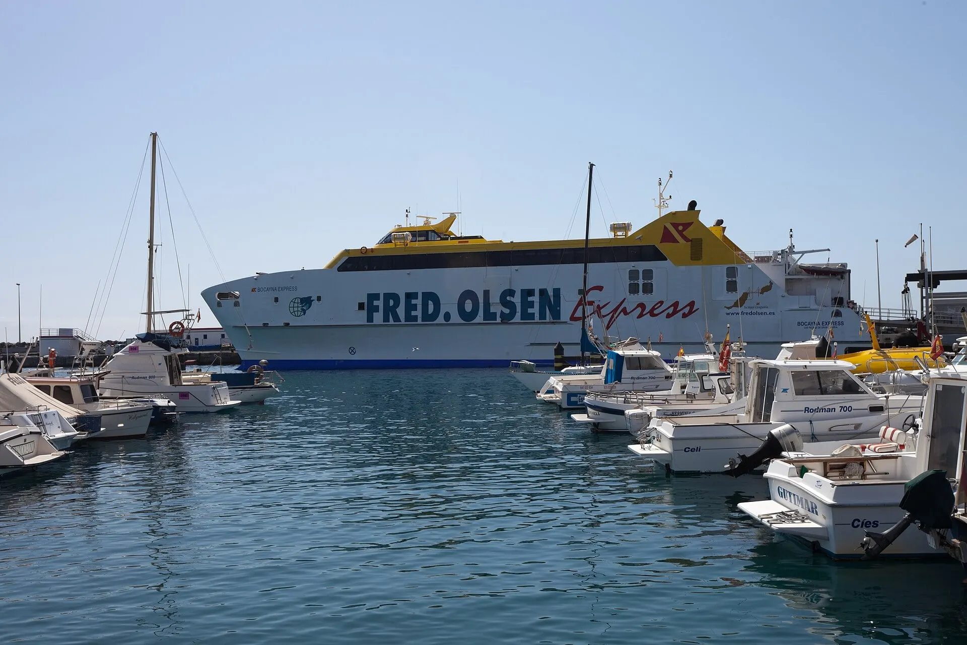 A Fred. Olsen Express ferry berthed at the port of Playa Blanca beside moored motorboats