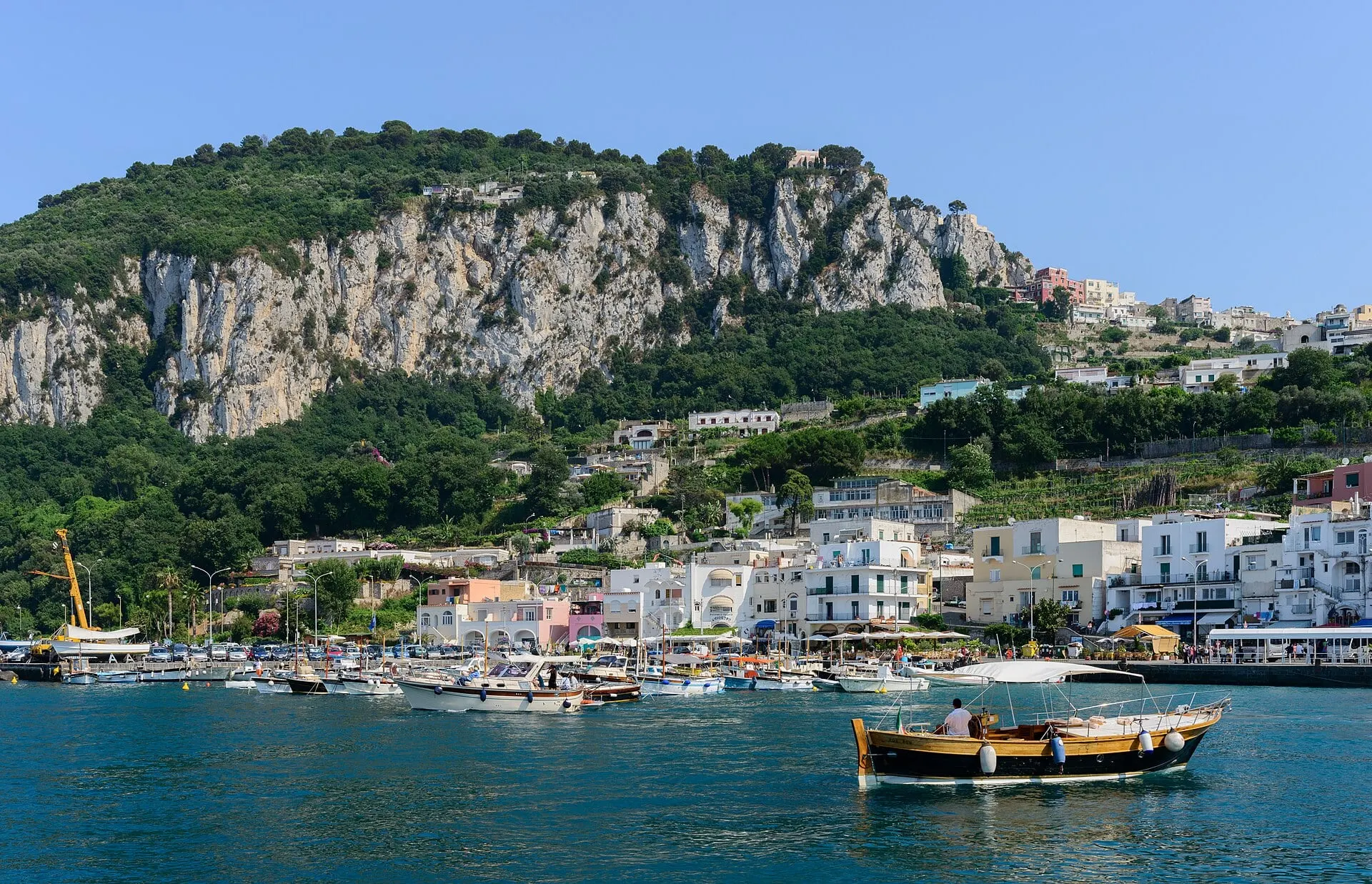 Marina Grande on Capri with boats at the harbour below green cliffs