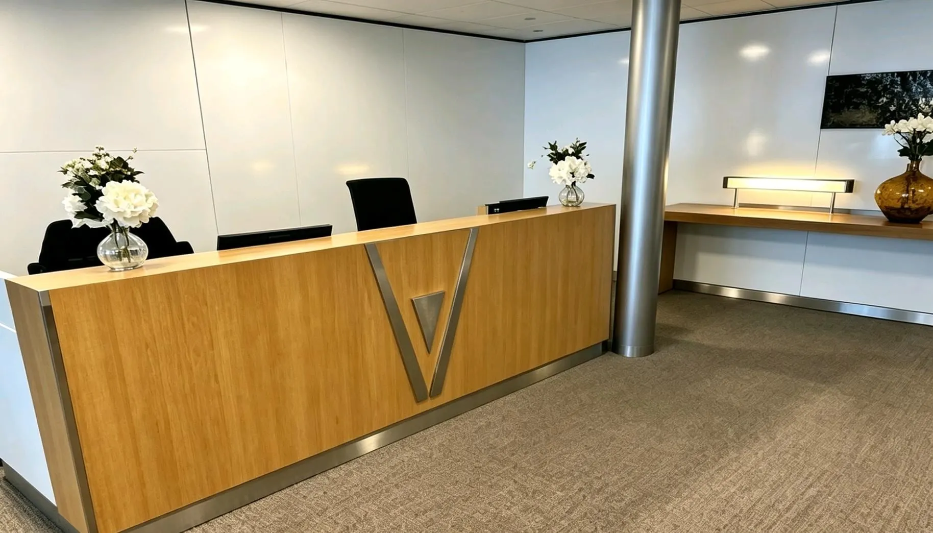 Wooden reception desk with white flowers at the lounge entrance