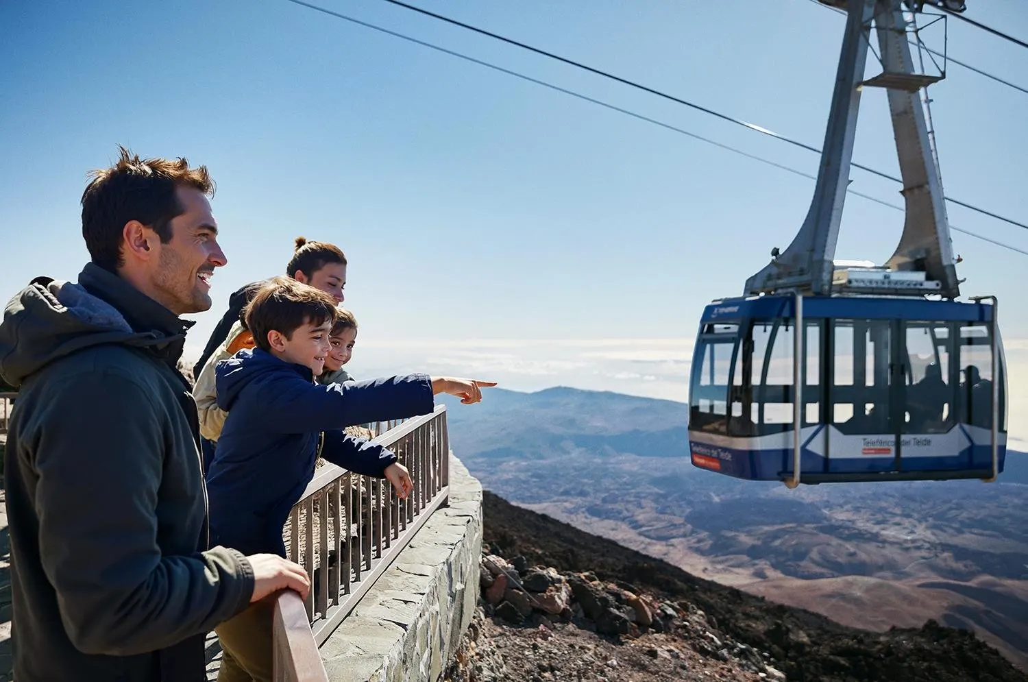 A family at the upper station watching a Teide cable car cabin arrive
