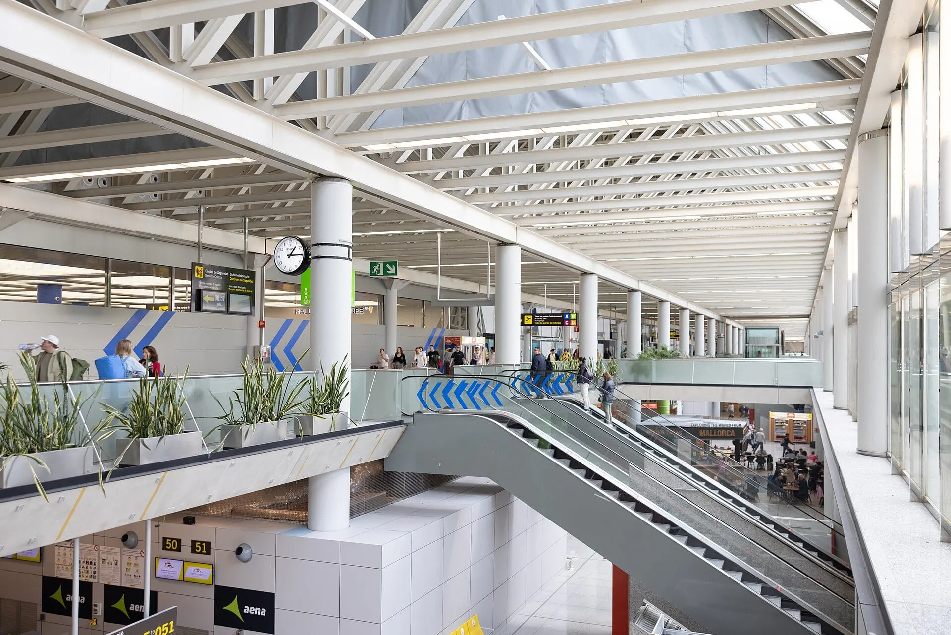The bright main hall at Palma de Mallorca Airport, with escalators down to check-in