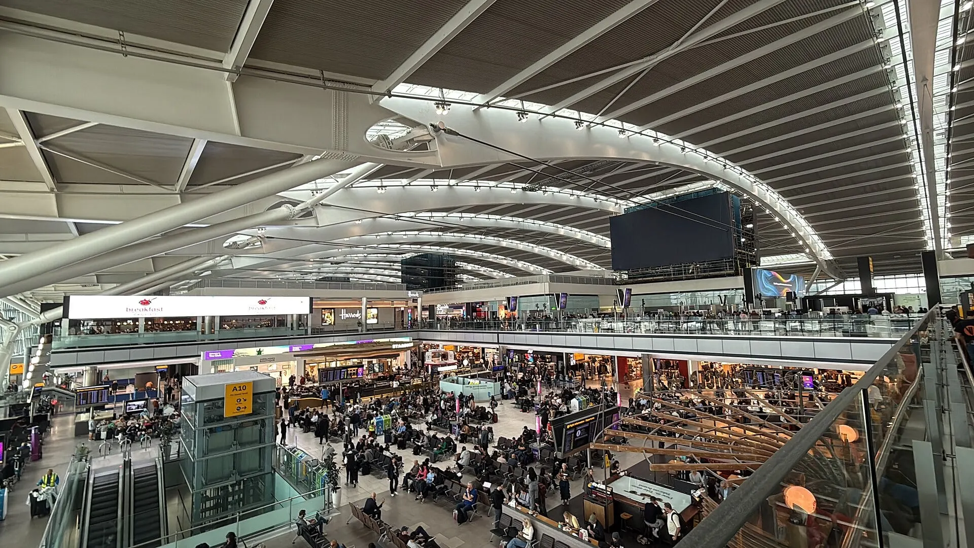The departures hall inside Heathrow Terminal 5, under its long curved roof