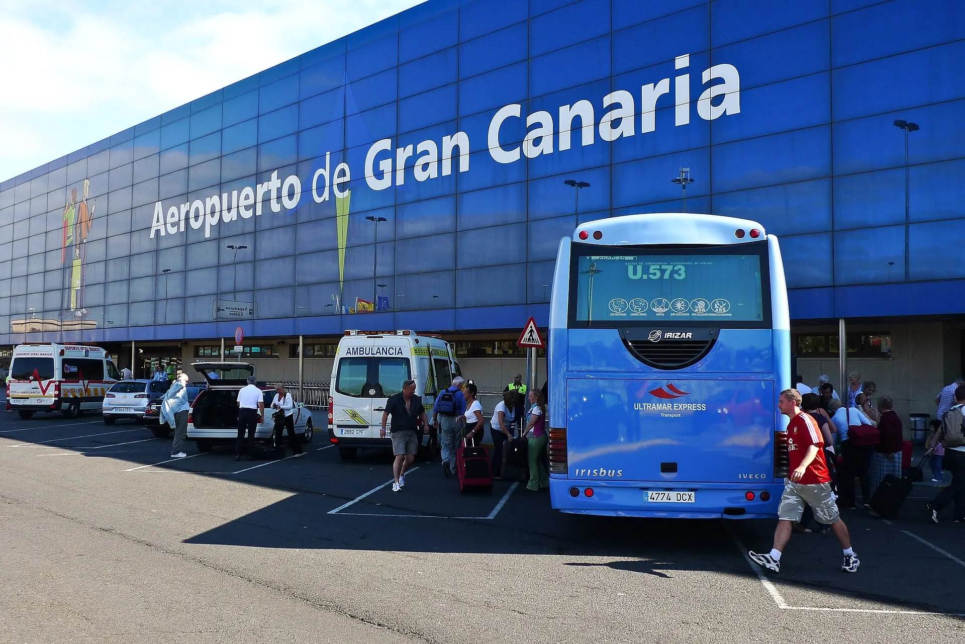 A coach at the kerb outside the blue terminal front at Gran Canaria Airport