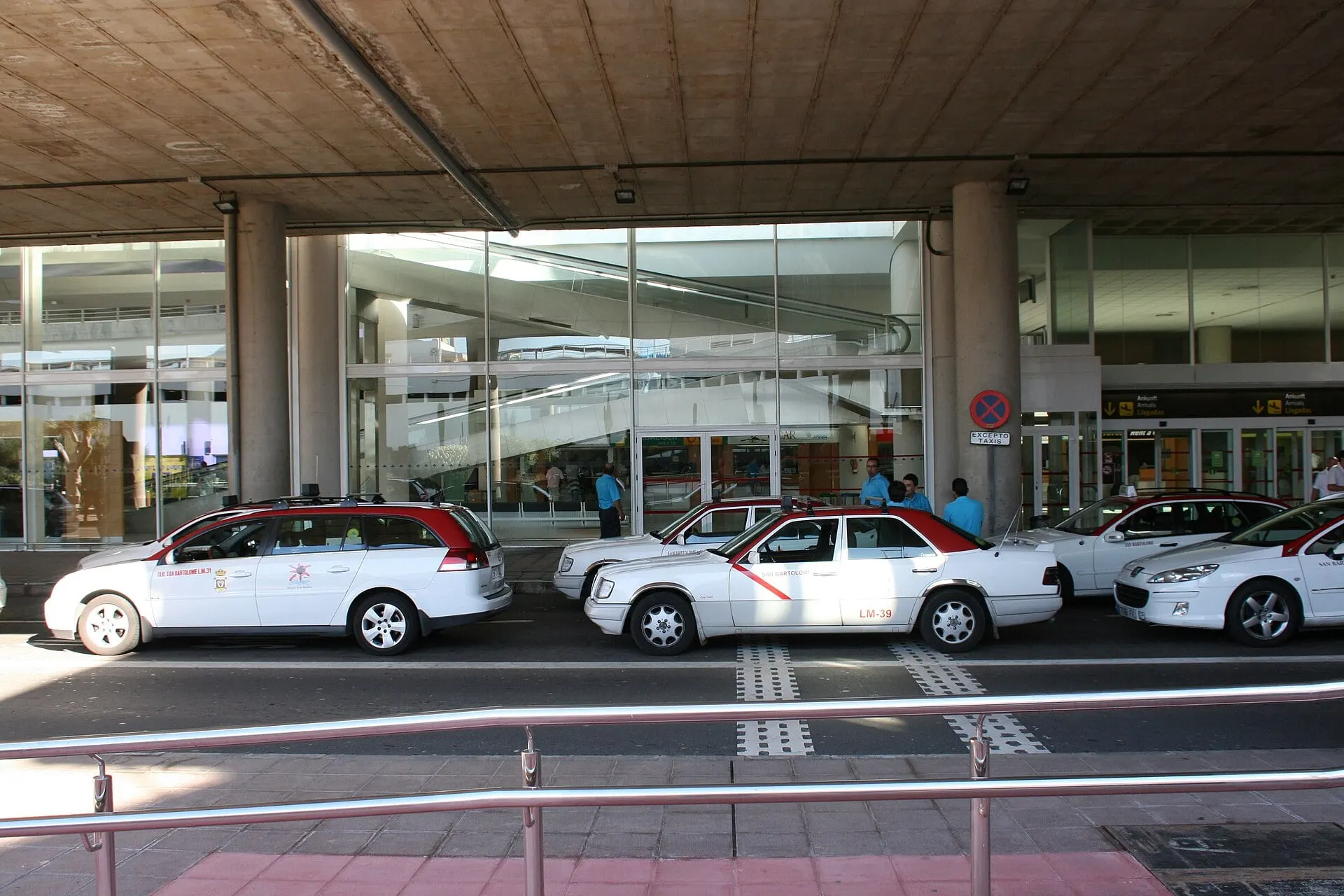 White taxis waiting at the rank outside the terminal at Lanzarote Airport