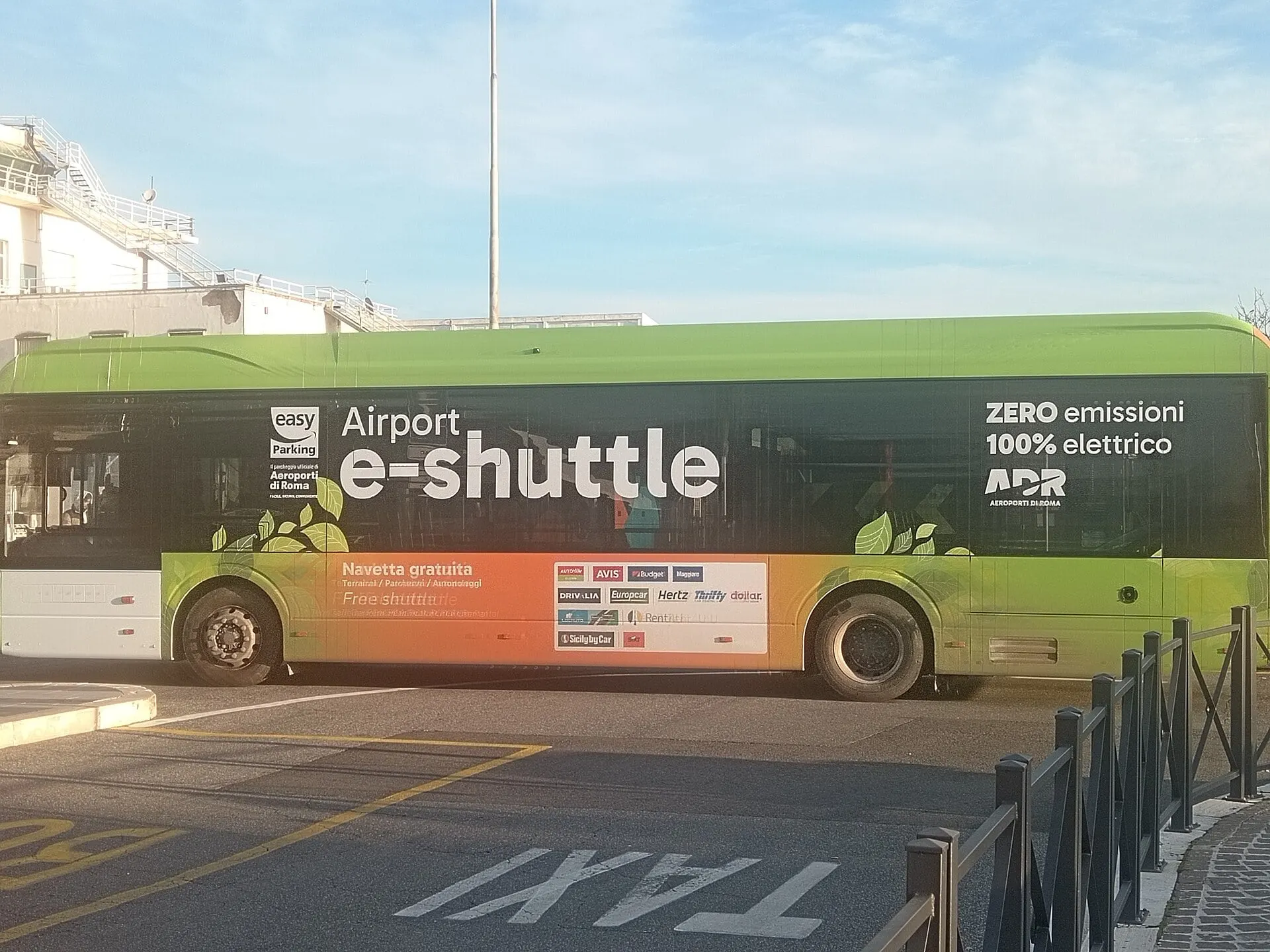 The electric Airport e-Shuttle bus waiting outside the terminal at Rome Ciampino