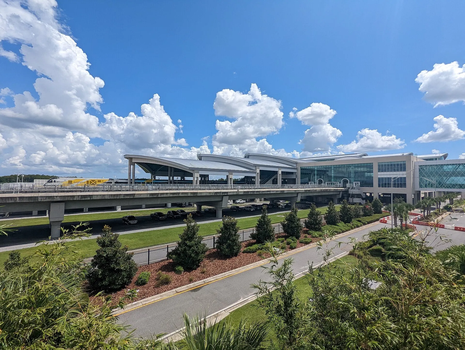 A Brightline train at the Orlando airport station beside Terminal C