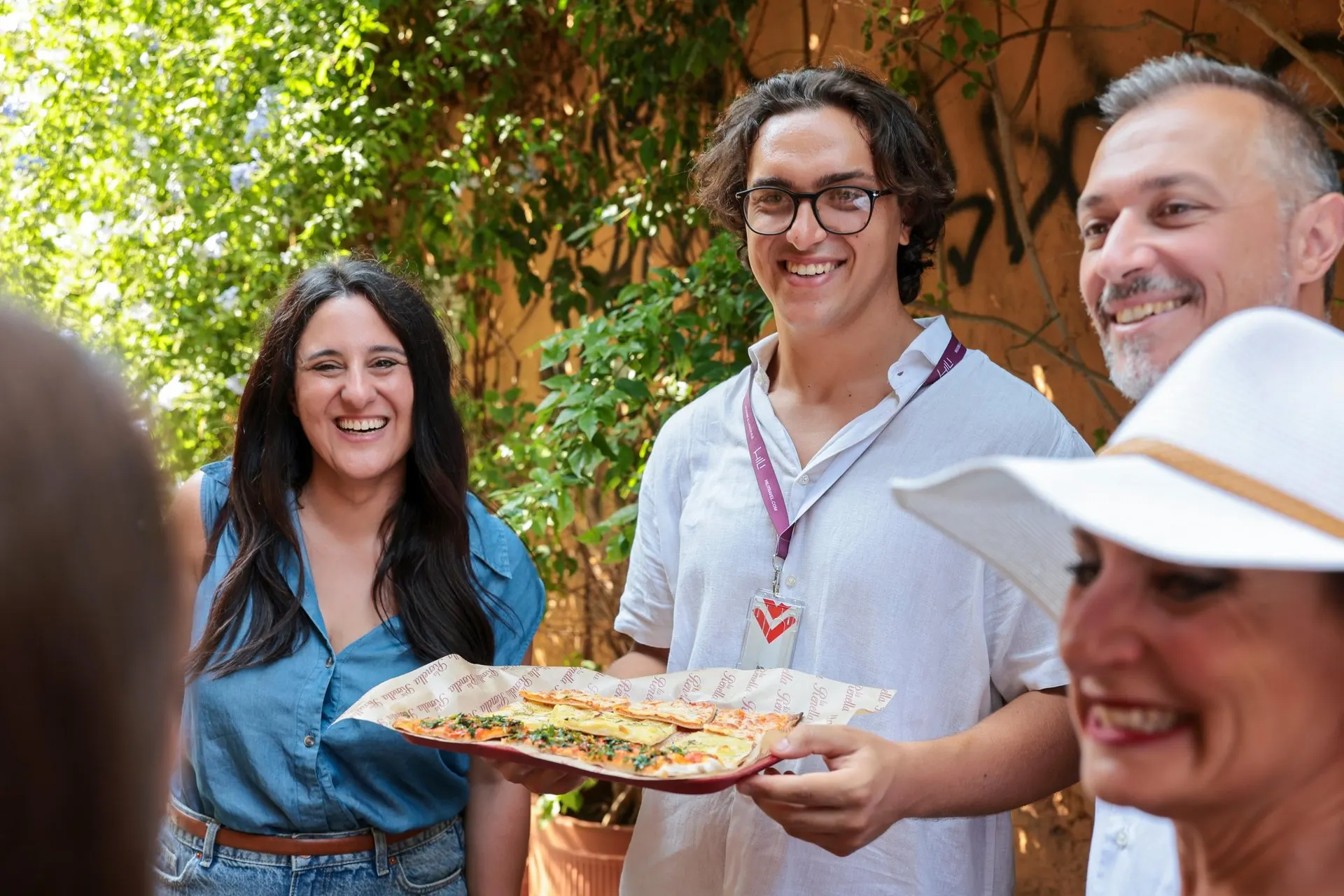 Guests sharing pizza with their guide