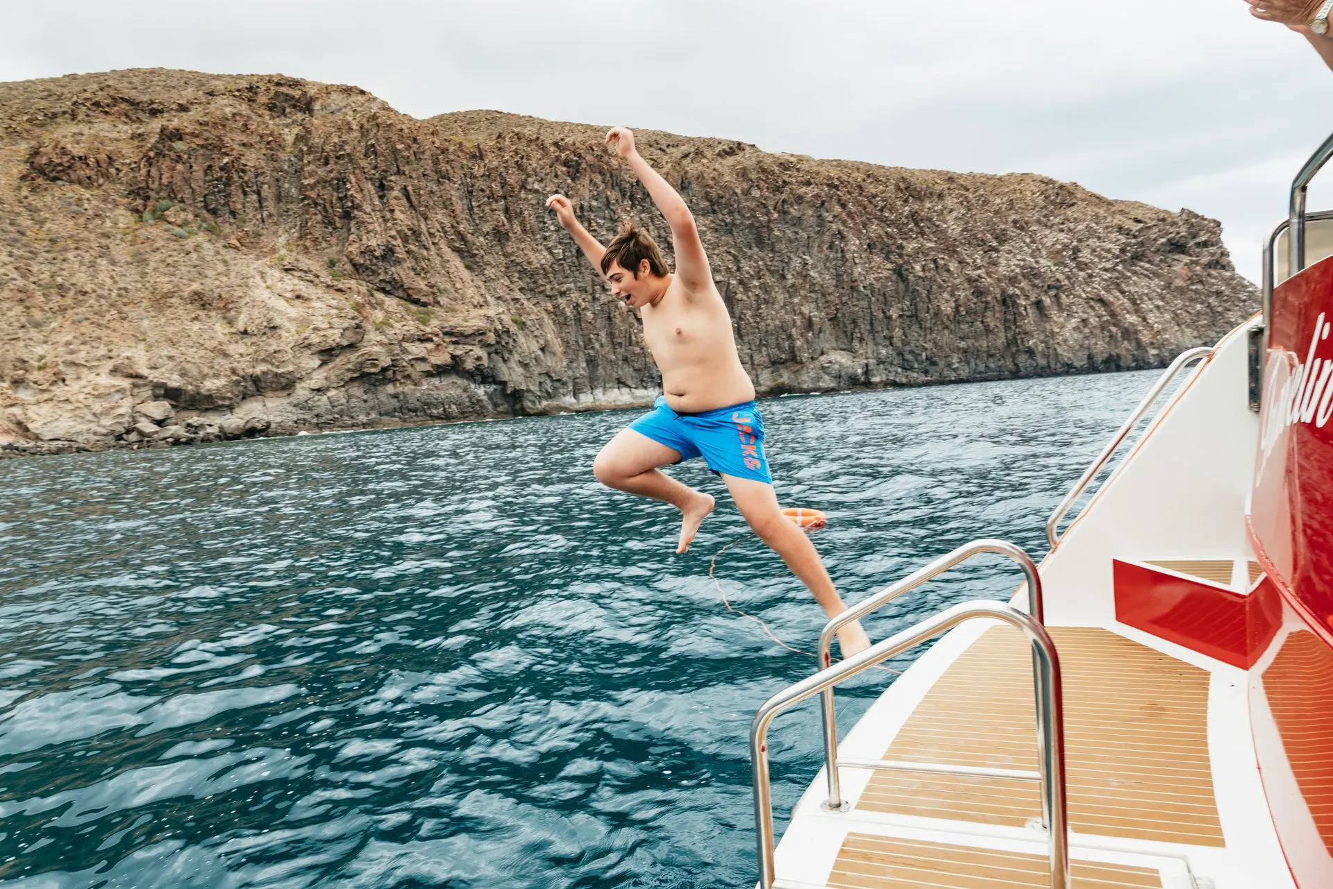 A passenger jumping from the yacht into the sea at the swim stop