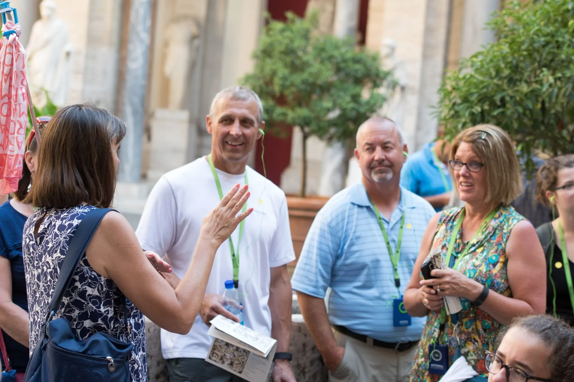 A guide talking to a group in a Vatican courtyard