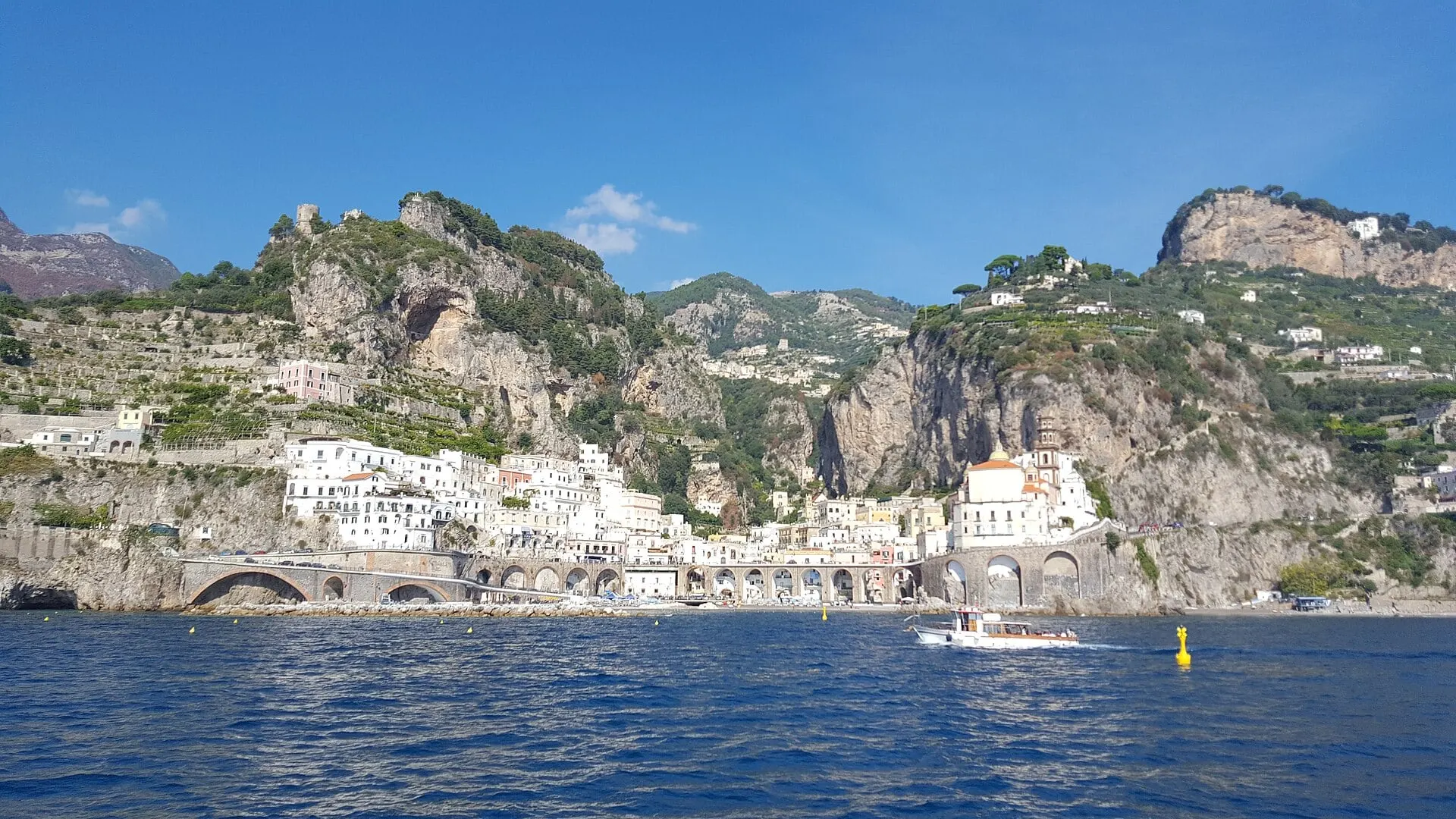 White villages on the cliffs of the Amalfi Coast seen from the water