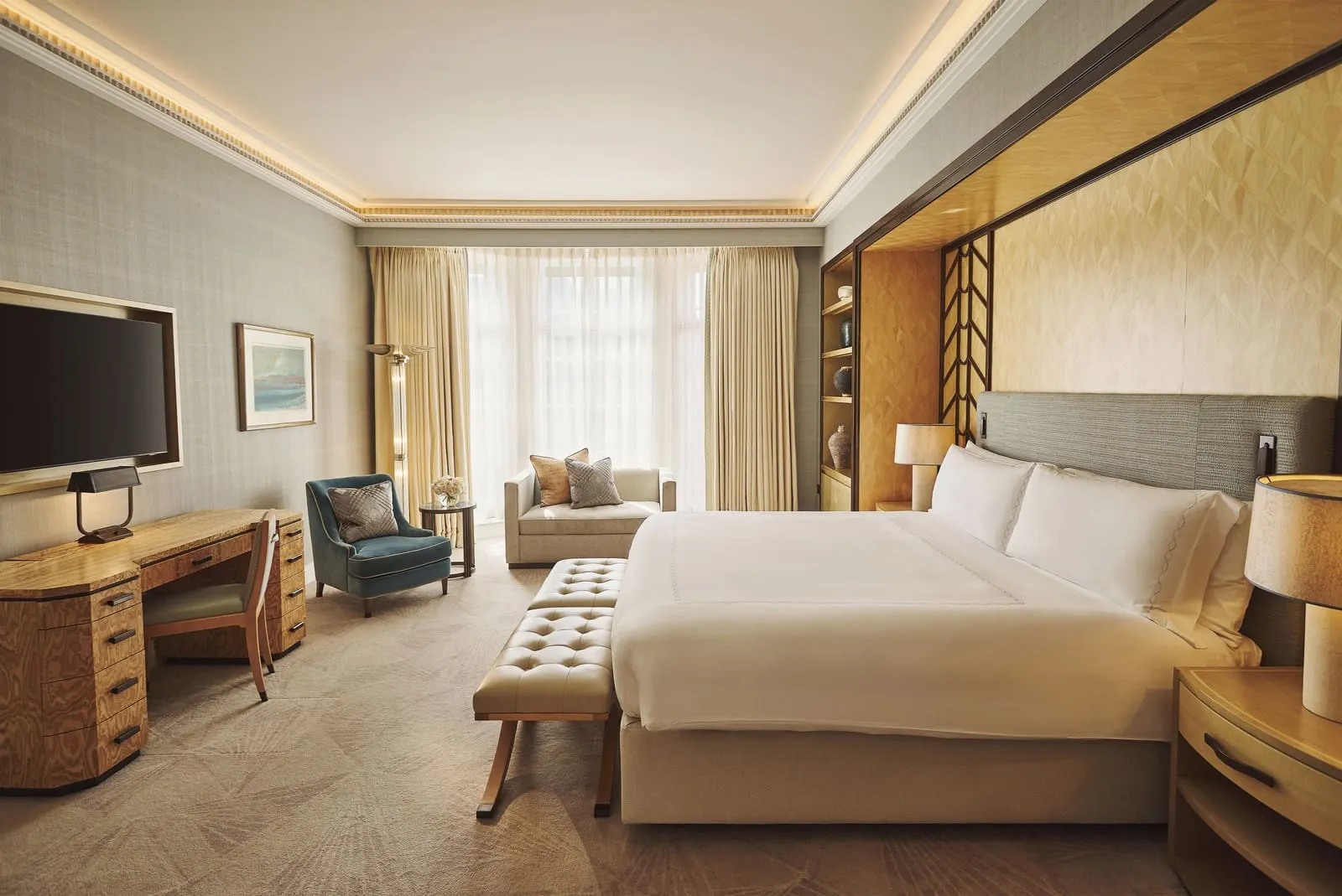 Claridge's Studio at Claridge's: the bed, a desk with a television, a blue armchair and a sofa by the window