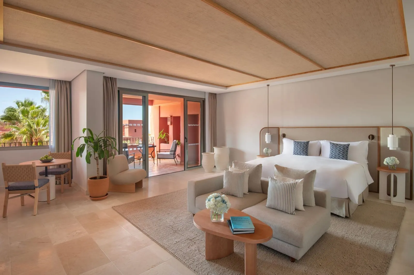 Junior Suite, Resort View at the Ritz-Carlton Abama: a king bed, a sofa, a coffee table and a dining table by the balcony