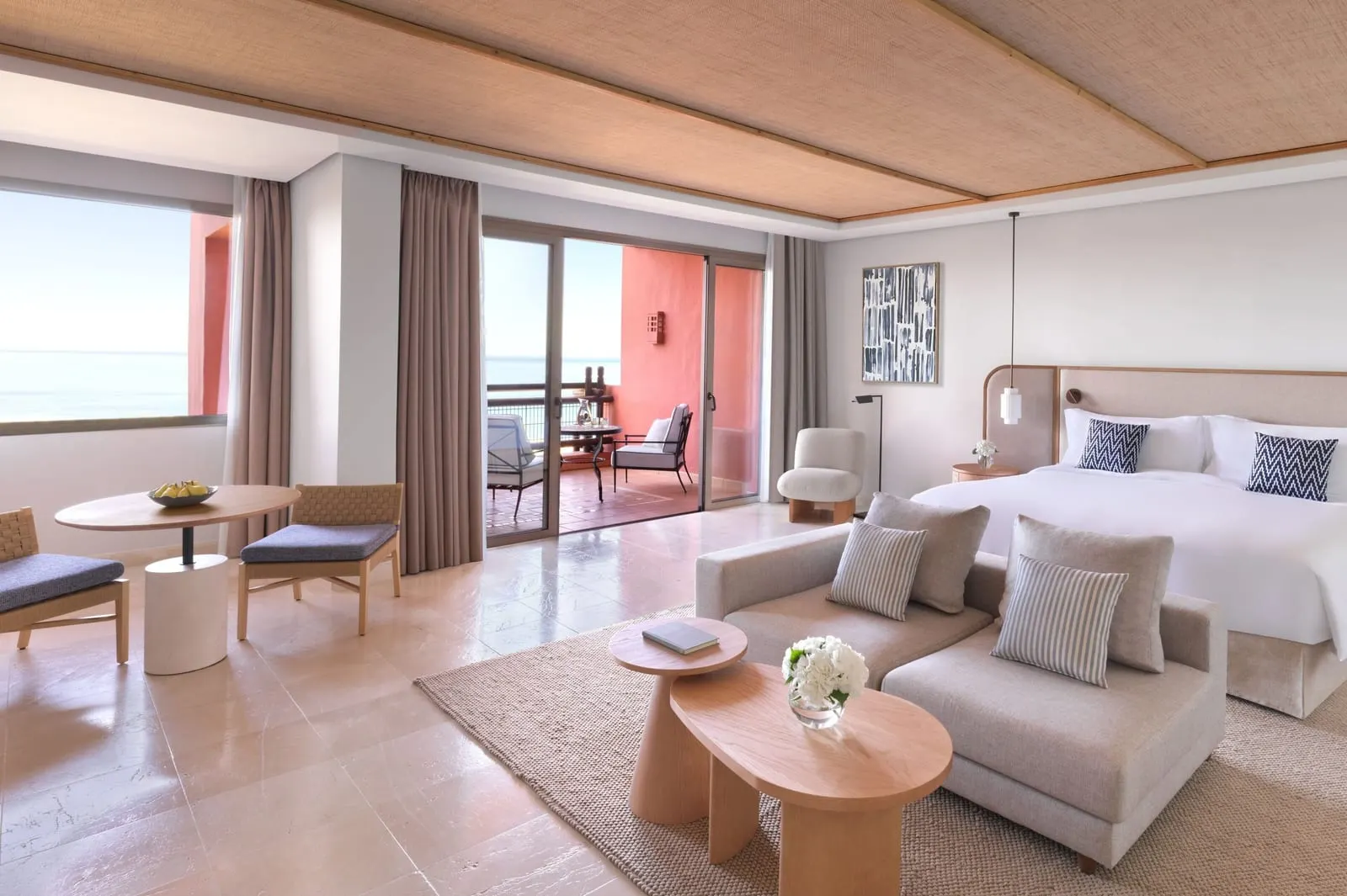 Junior Suite, Ocean View at the Ritz-Carlton Abama: a king bed, a sofa and a table for two by the balcony doors